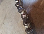 new chain with one of the rivet pins ground down, to make it easier to push through